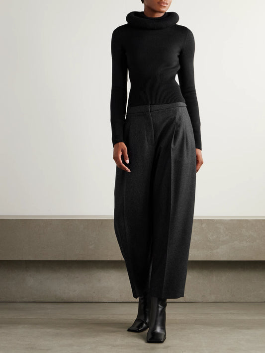 Image of a model wearing Outerwear. Product name - Wool Sweater in Black colour by brand - Alaïa