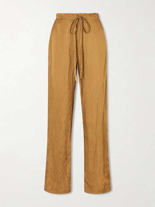 Image of a model wearing Pants. Product name - Rohen Crinkled-voile Pants in Gold colour by brand - KHAITE