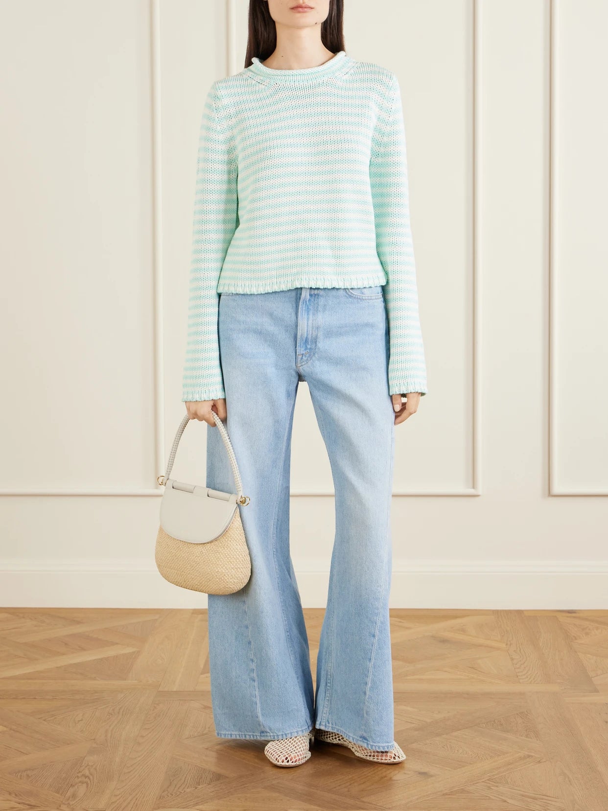 Image of a model wearing Outerwear. Product name - Mini Marina Cropped Striped Cotton Sweater in Multi colour by brand - La Ligne