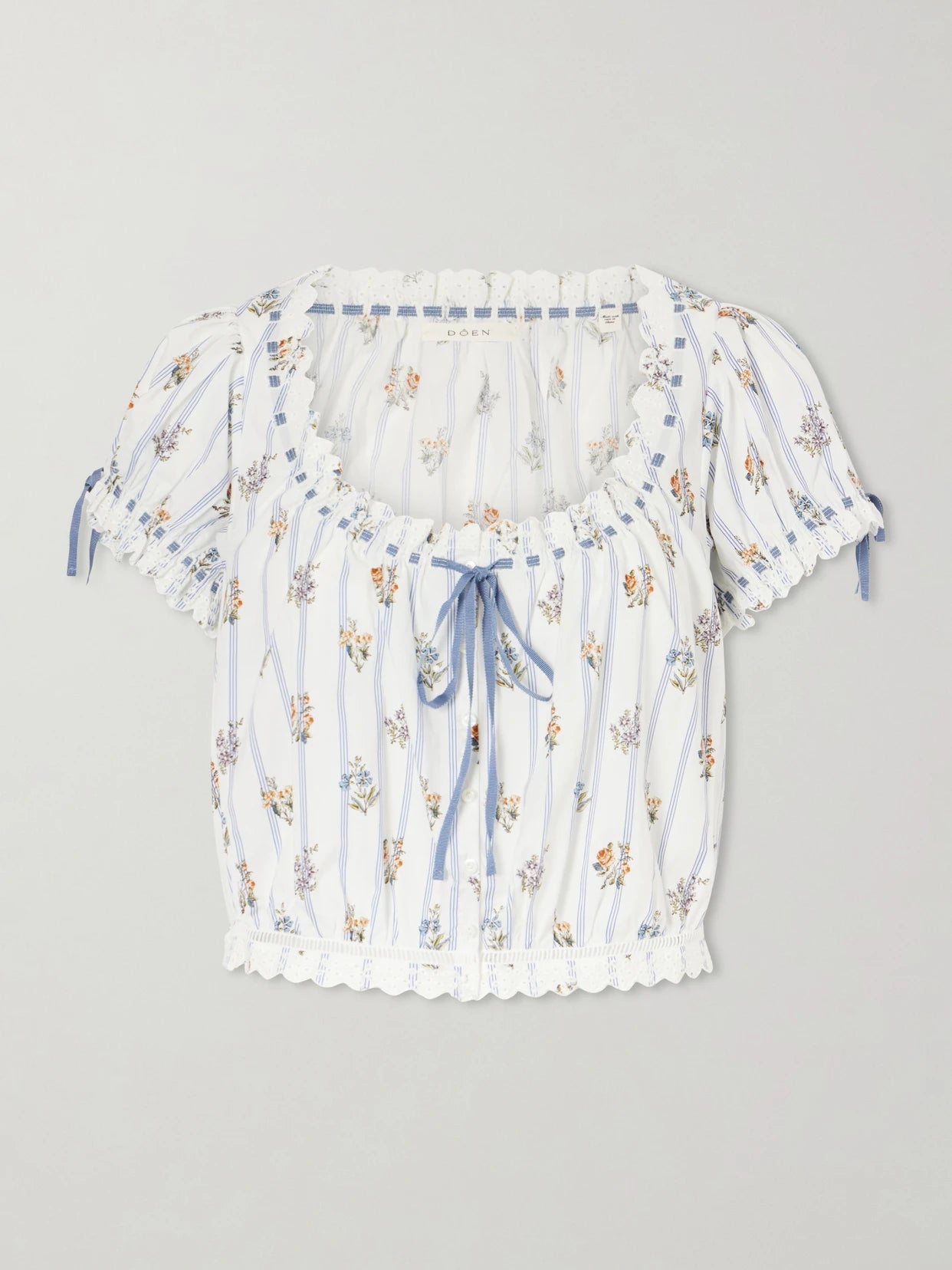 Image of a model wearing Tops. Product name - Nera Broderie Anglaise Organic Cotton Blouse in White colour by brand - DÔEN