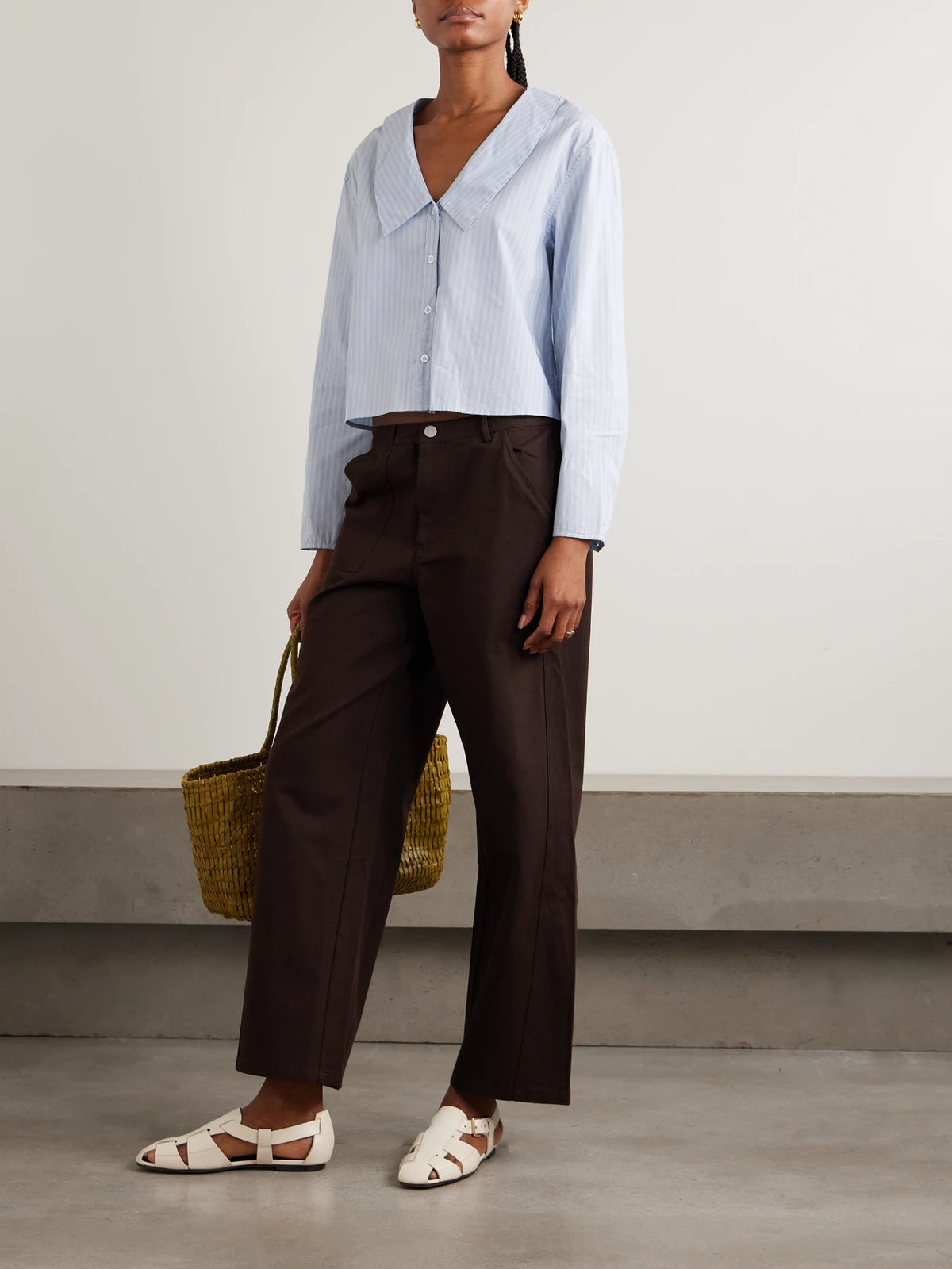 Image of a model wearing Tops. Product name - Striped Organic Cotton Shirt in Blue colour by brand - Deiji Studios