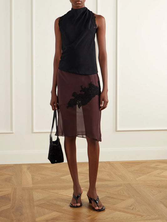 Image of a model wearing Tops. Product name - Tie-detailed Lace-trimmed Satin Top in Black colour by brand - SIR.