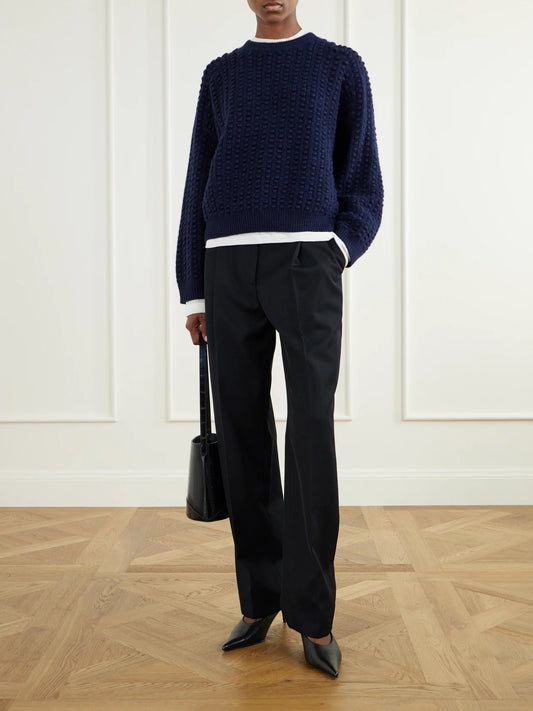 Image of a model wearing Outerwear. Product name - Rolf Bubble-stitch Cashmere Sweater in Navy colour by brand - Loulou de Saison