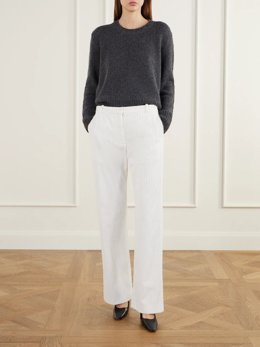 Image of a model wearing Pants. Product name - Kenton Mid-rise Cotton-corduroy Straight-leg Pants in Off-white colour by brand - The Row