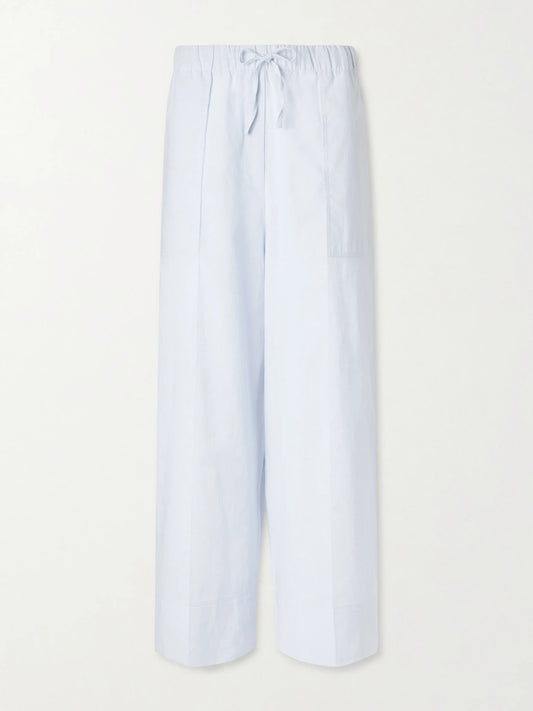 Image of a model wearing Pants. Product name - Cotton And Linen-blend Wide-leg Pants in Light blue colour by brand - TOTEME