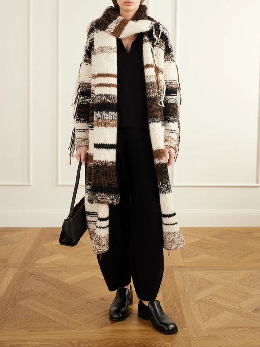 Image of a model wearing Pants. Product name - Merino Wool, Alpaca And Pima Cotton-blend Knitted Tapered Pants in Black colour by brand - Lauren Manoogian