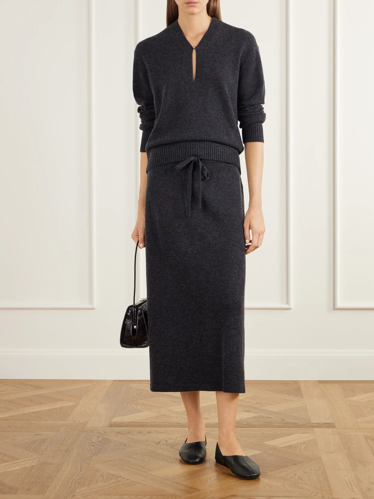 Image of a model wearing Skirts. Product name - Drawstring Wool And Cashmere-blend Knitted Midi Skirt in Charcoal colour by brand - Allude