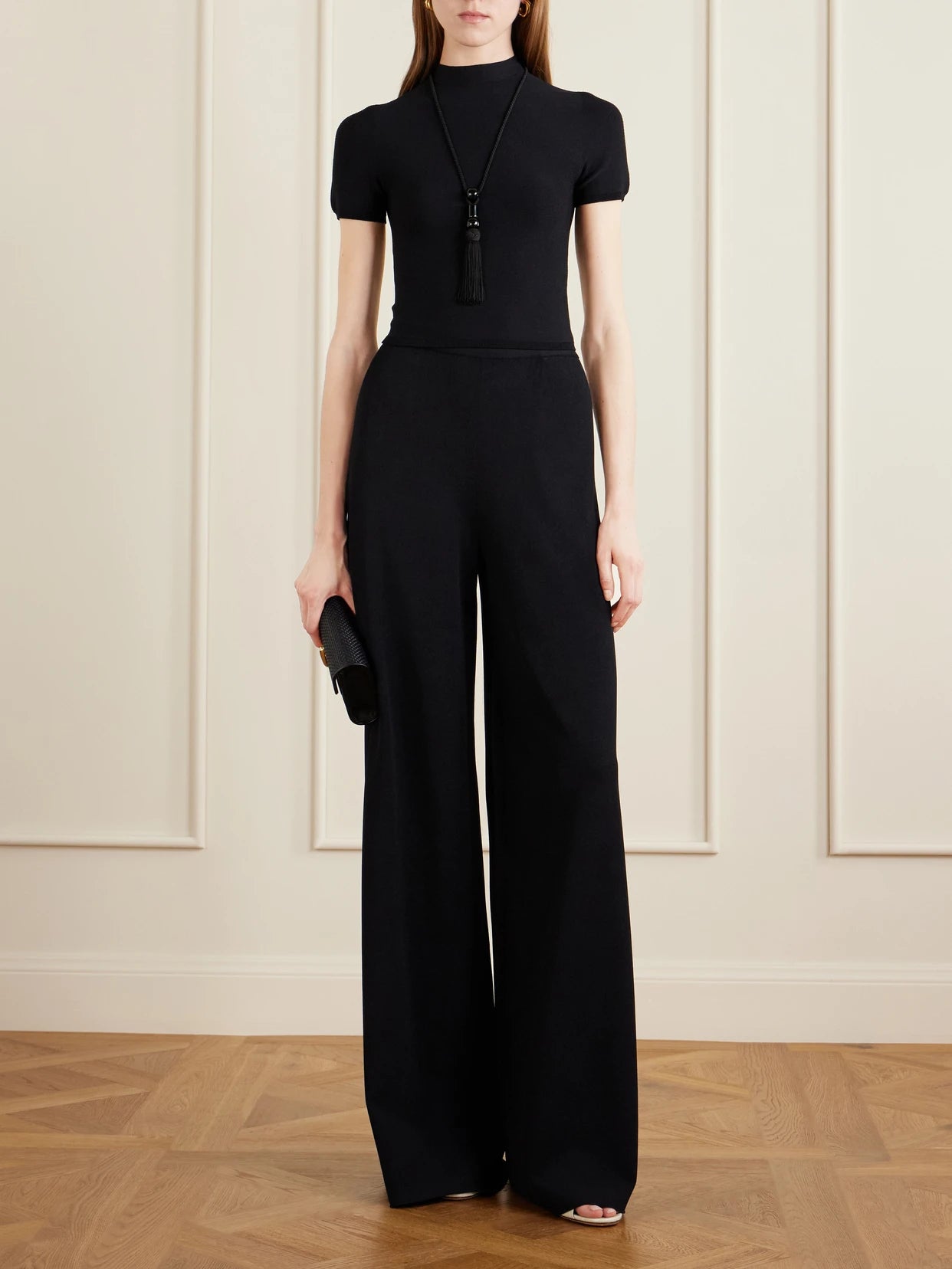 Image of a model wearing Pants. Product name - Stretch-jersey Mid-rise Wide-leg Pants in Black colour by brand - Ralph Lauren Collection