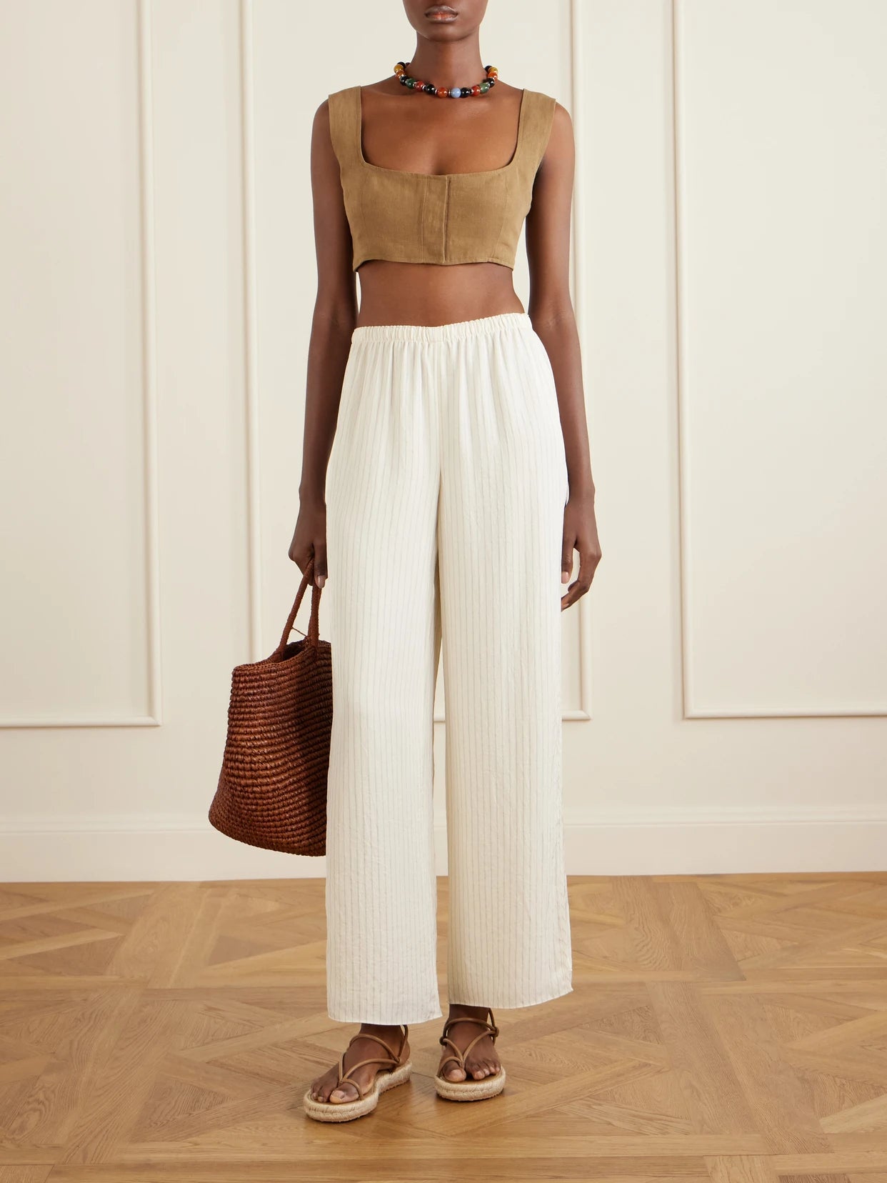 Image of a model wearing Tops. Product name - Jirja Linen Cropped Top in Brown colour by brand - Le Kasha
