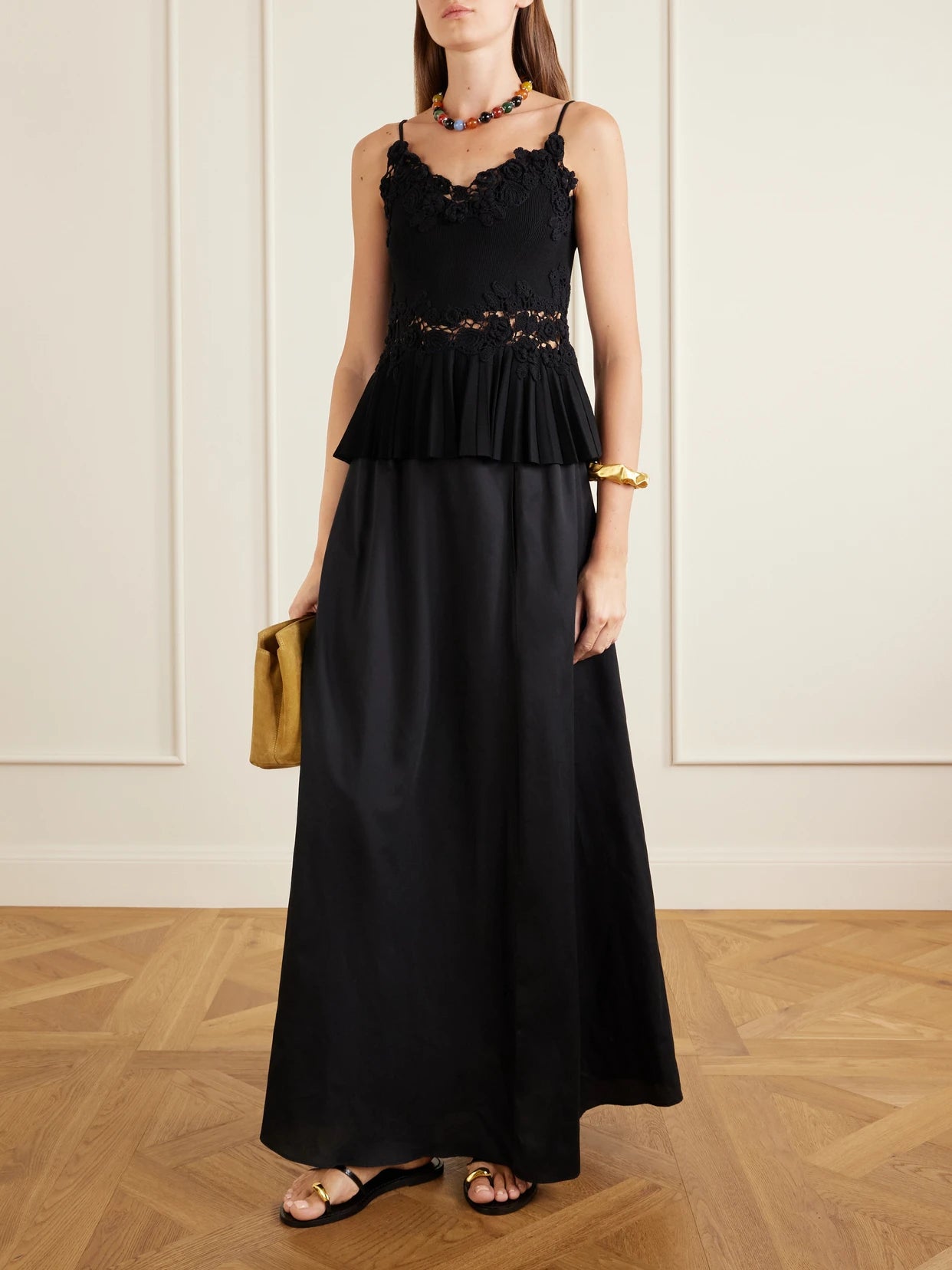Image of a model wearing Tops. Product name - Estelle Pleated Crochet-trimmed Ribbed Jersey Tank in Black colour by brand - Ulla Johnson