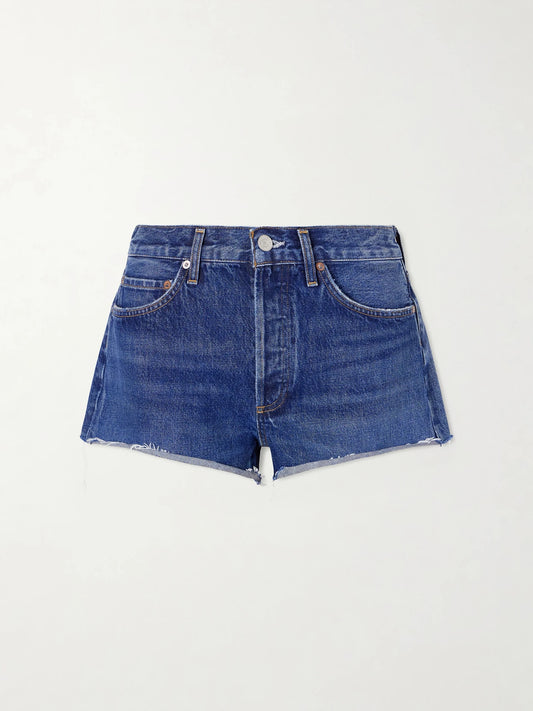 Image of a model wearing Shorts. Product name - Parker Frayed Denim Short in Dark denim colour by brand - AGOLDE