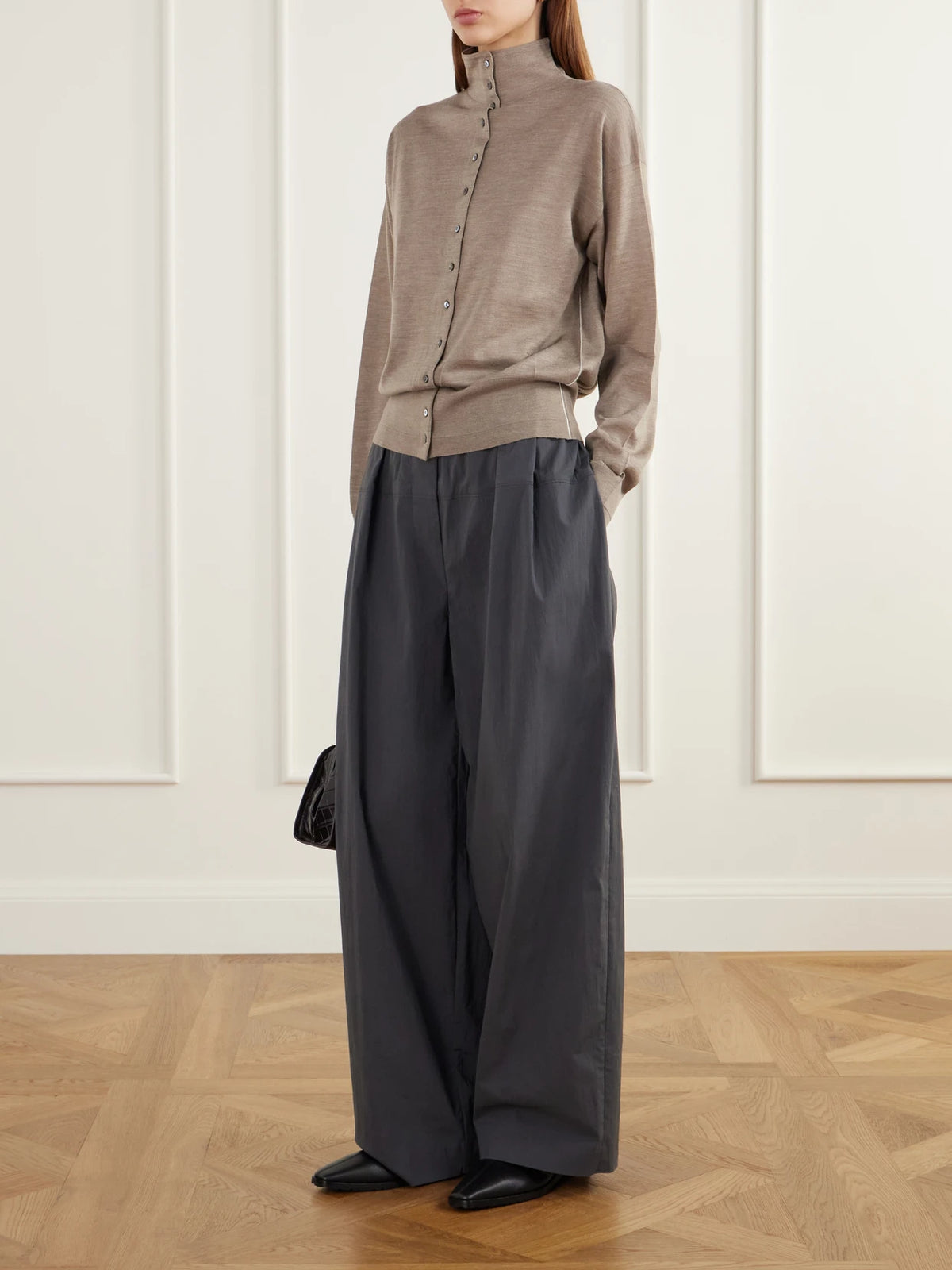 Image of a model wearing Outerwear. Product name - Merino Wool Turtleneck Cardigan in Taupe colour by brand - Maria McManus