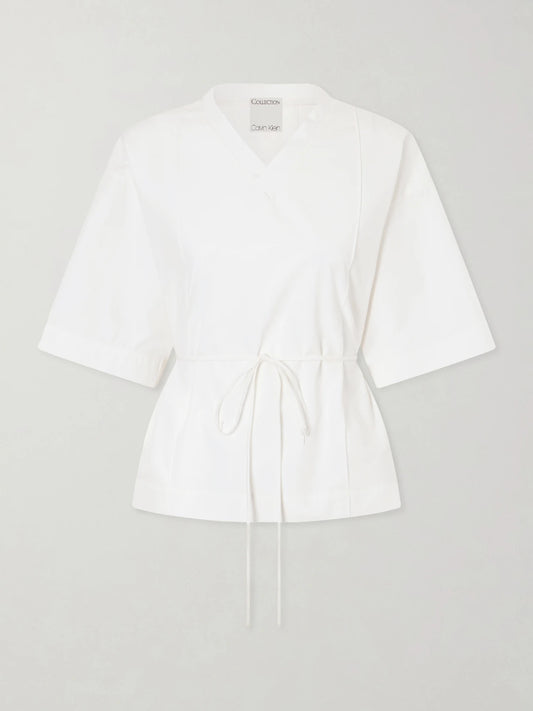 Image of a model wearing Tops. Product name - Lynn Cotton-poplin Wrap Blouse in Off-white colour by brand - Calvin Klein Collection