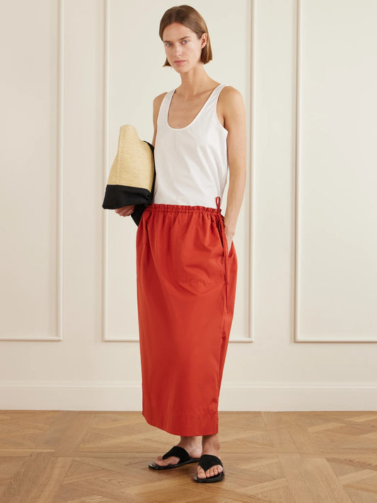 Image of a model wearing Skirts. Product name - Cotton-poplin Midi Skirt in Red colour by brand - TOTEME