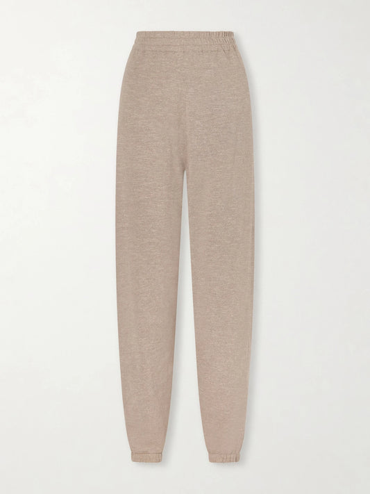 Image of a model wearing Pants. Product name - Nadir Tapered Cotton And Linen-blend Pants in Cream colour by brand - The Row