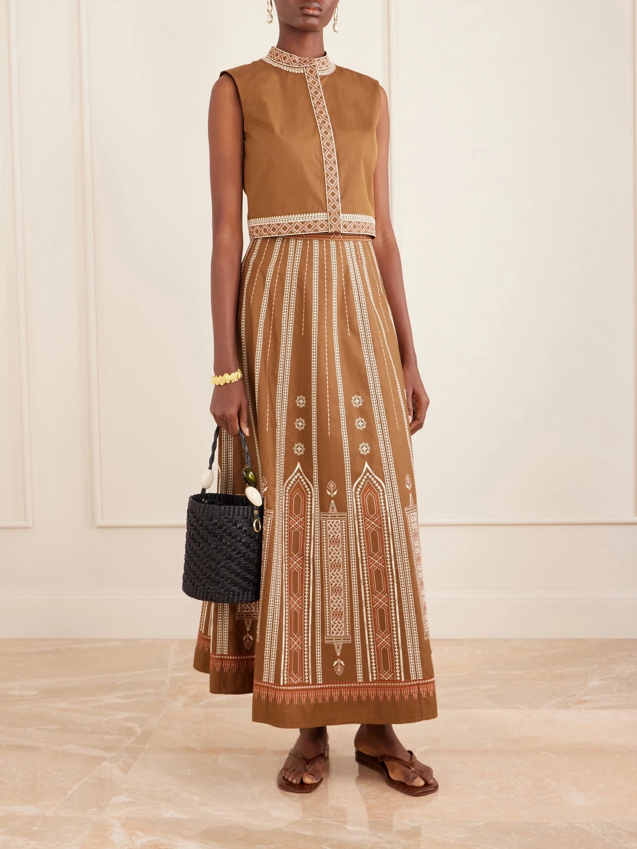Image of a model wearing Tops. Product name - Andorra Cropped Embroidered Lace-trimmed Cotton-blend Poplin Top in Brown colour by brand - Emporio Sirenuse