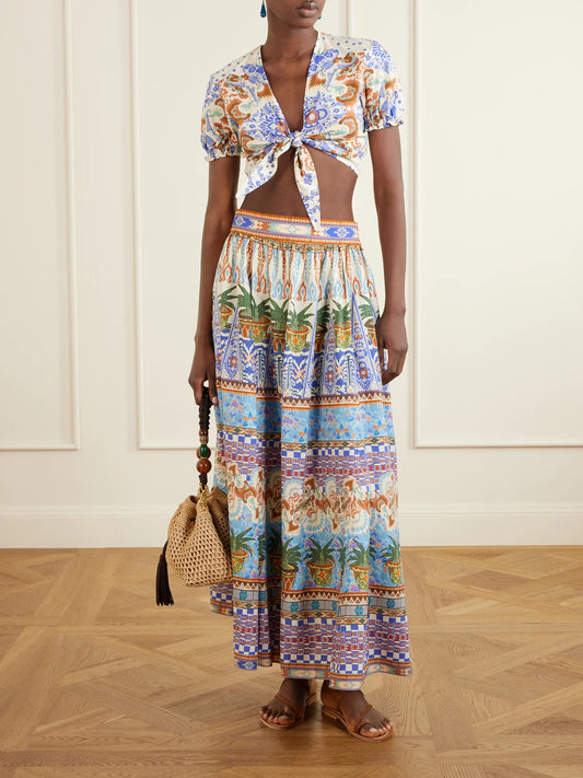 Image of a model wearing Skirts. Product name - Ombretta Pleated Printed Cotton Midi Skirt in Blue colour by brand - Emporio Sirenuse