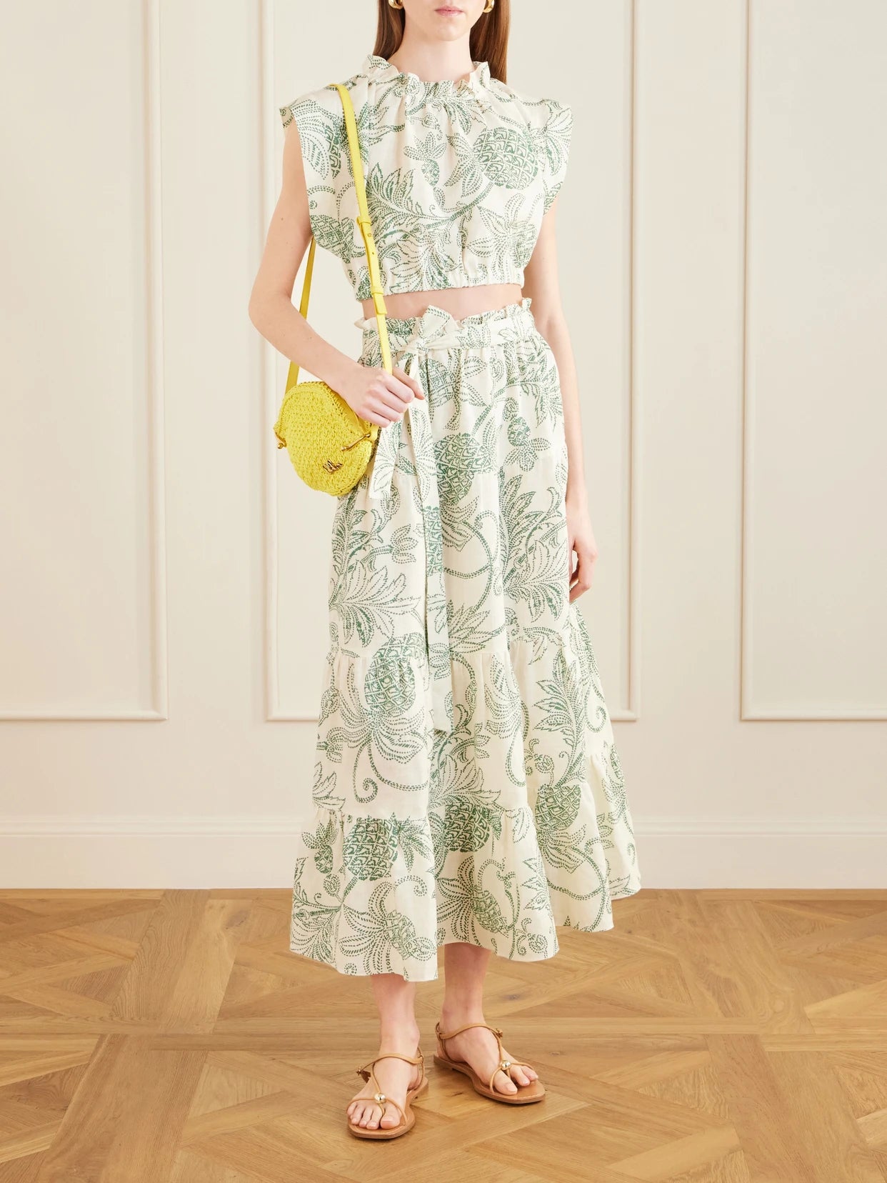 Image of a model wearing Tops. Product name - Muna Cropped Ruched Printed Linen Top in Green colour by brand - lemlem