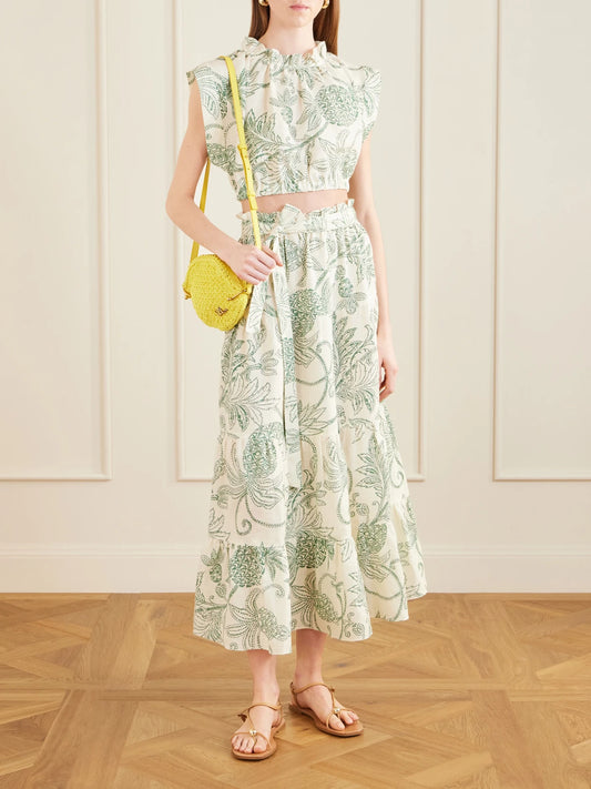 Image of a model wearing Tops. Product name - Muna Cropped Ruched Printed Linen Top in Green colour by brand - lemlem