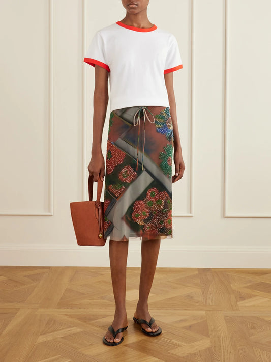 Image of a model wearing Skirts. Product name - Lucia Bead-embellished Printed Tulle Midi Skirt in Multi colour by brand - STAUD