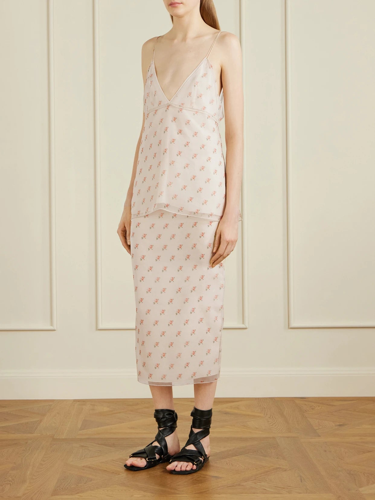 Image of a model wearing Skirts. Product name - Sydni Floral-print Silk-organza Midi Skirt in Pastel pink colour by brand - KHAITE