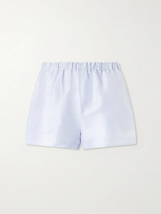 Image of a model wearing Shorts. Product name - Mori Linen And Silk-blend Satin Shorts in Light blue colour by brand - Cult Gaia