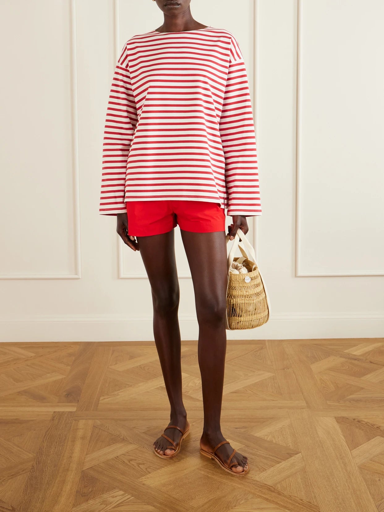 Image of a model wearing Tops. Product name - Breton Striped Cotton-jersey T-shirt in Red colour by brand - Matteau