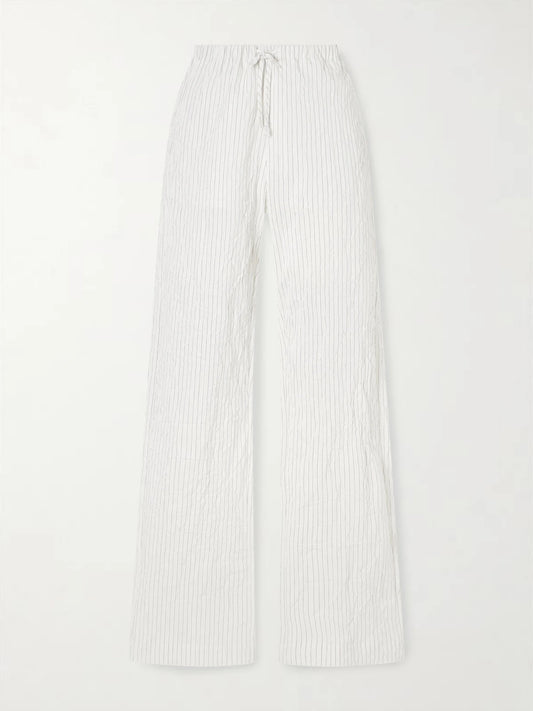 Image of a model wearing Pants. Product name - Striped Crepon Wide-leg Pants in White colour by brand - RÓHE