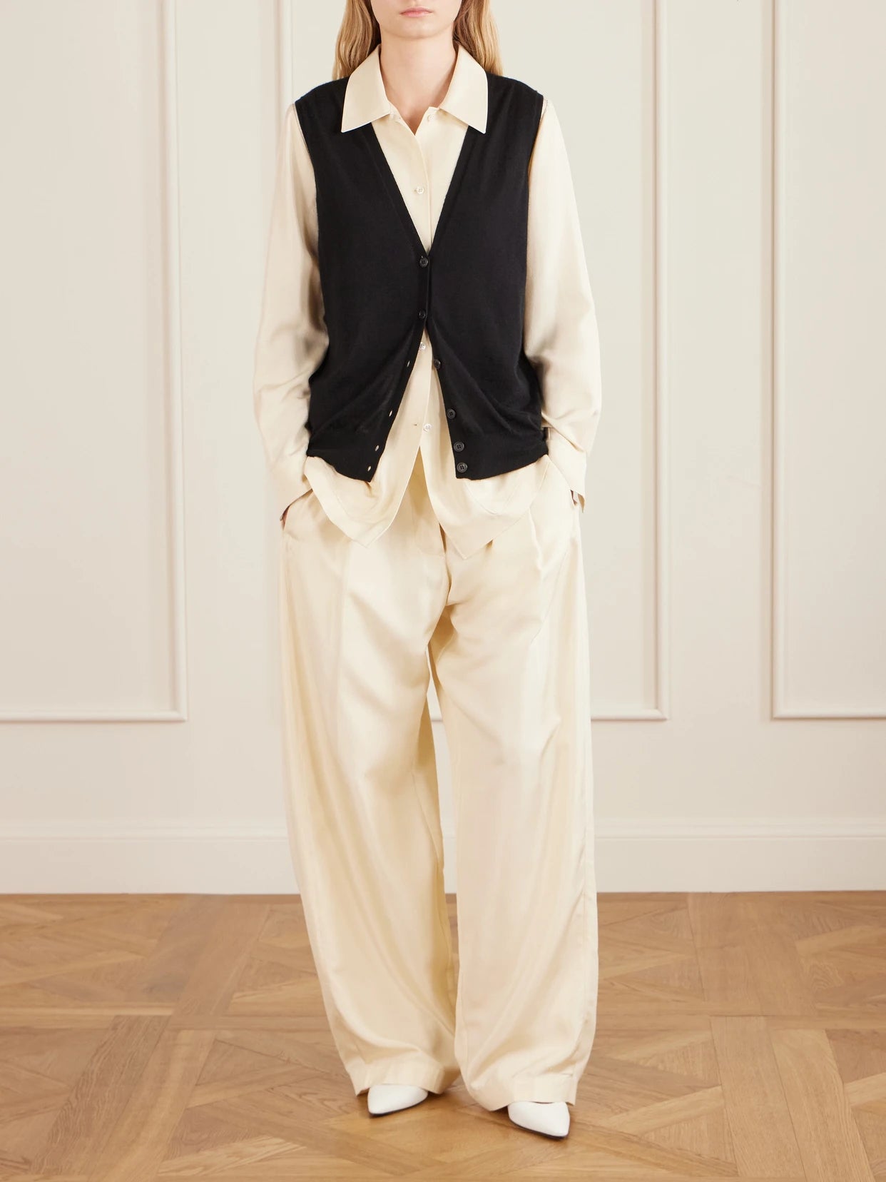 Image of a model wearing Outerwear. Product name - Neel Cashmere Vest in Black colour by brand - The Row