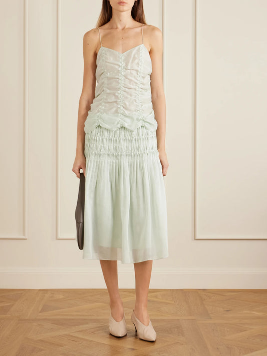 Image of a model wearing Tops. Product name - Inara Ruched Lyocell And Silk-blend Tank in Light green colour by brand - KHAITE