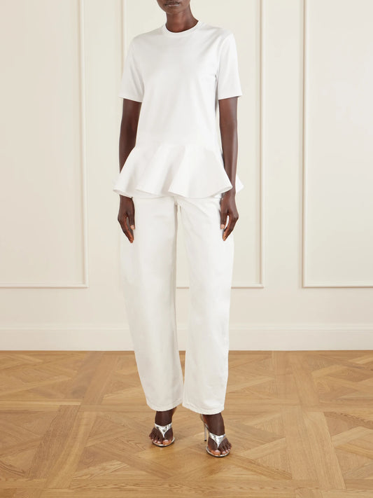 Image of a model wearing Tops. Product name - Peplum Cotton-jersey T-shirt in White colour by brand - Alaïa
