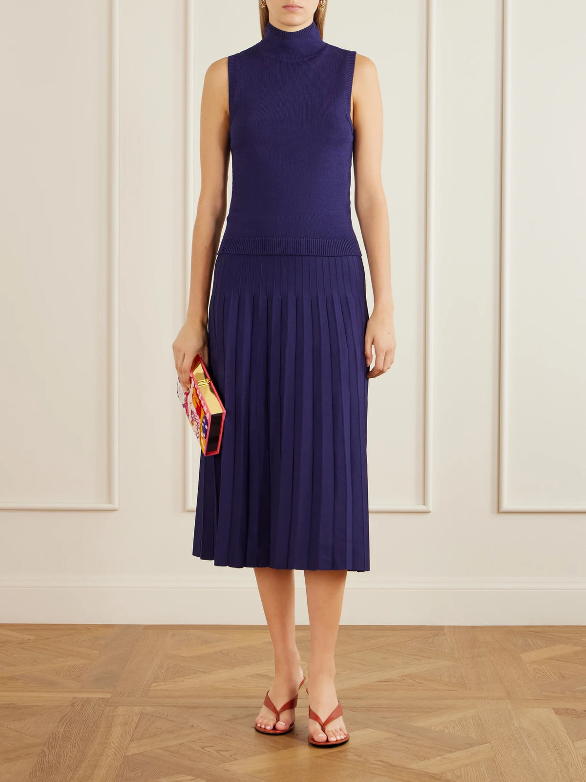 Image of a model wearing Skirts. Product name - Lena Pleated Knitted Midi Skirt in Midnight blue colour by brand - STAUD