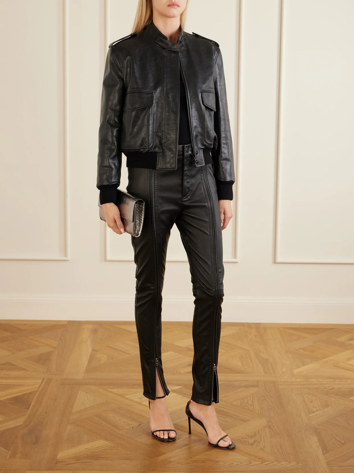 Image of a model wearing Pants. Product name - Zip-up Leather Skinny-leg Pants in Black colour by brand - TOM FORD