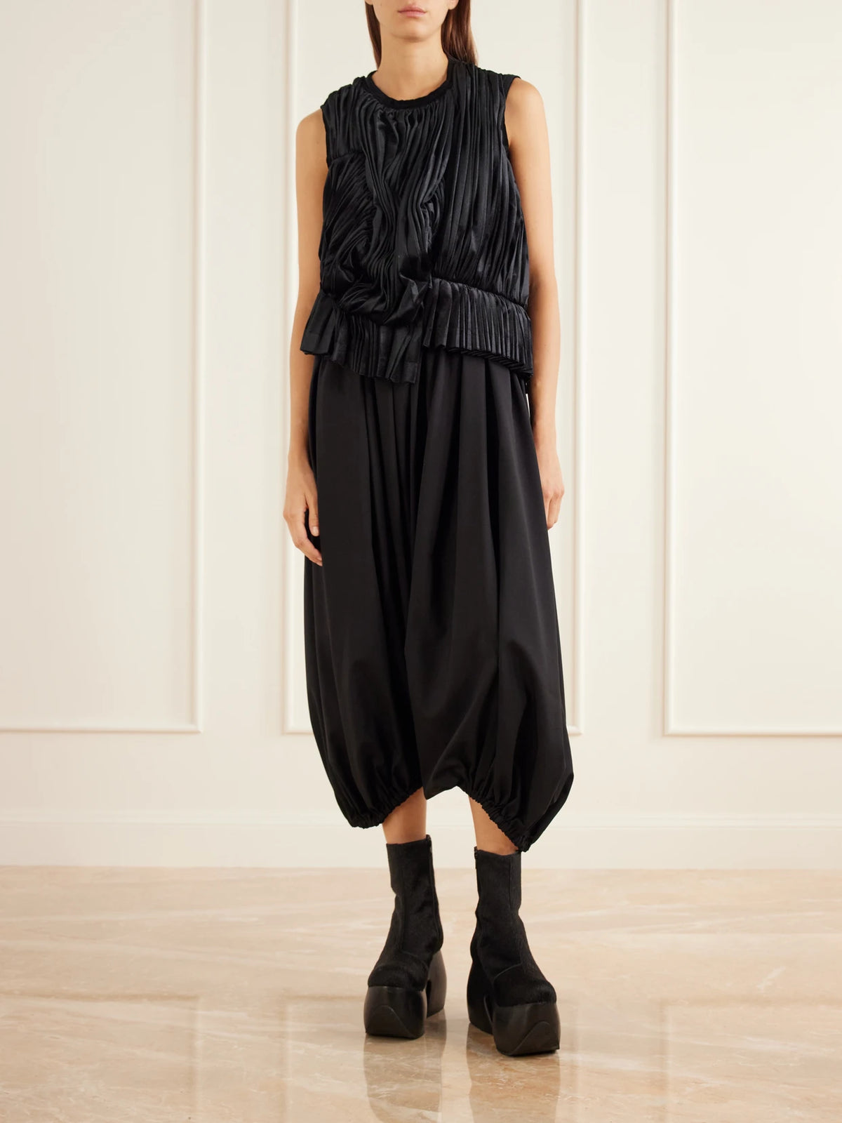 Image of a model wearing Tops. Product name - Asymmetric Pleated Draped Jersey-velour Top in Black colour by brand - Comme des Garçons