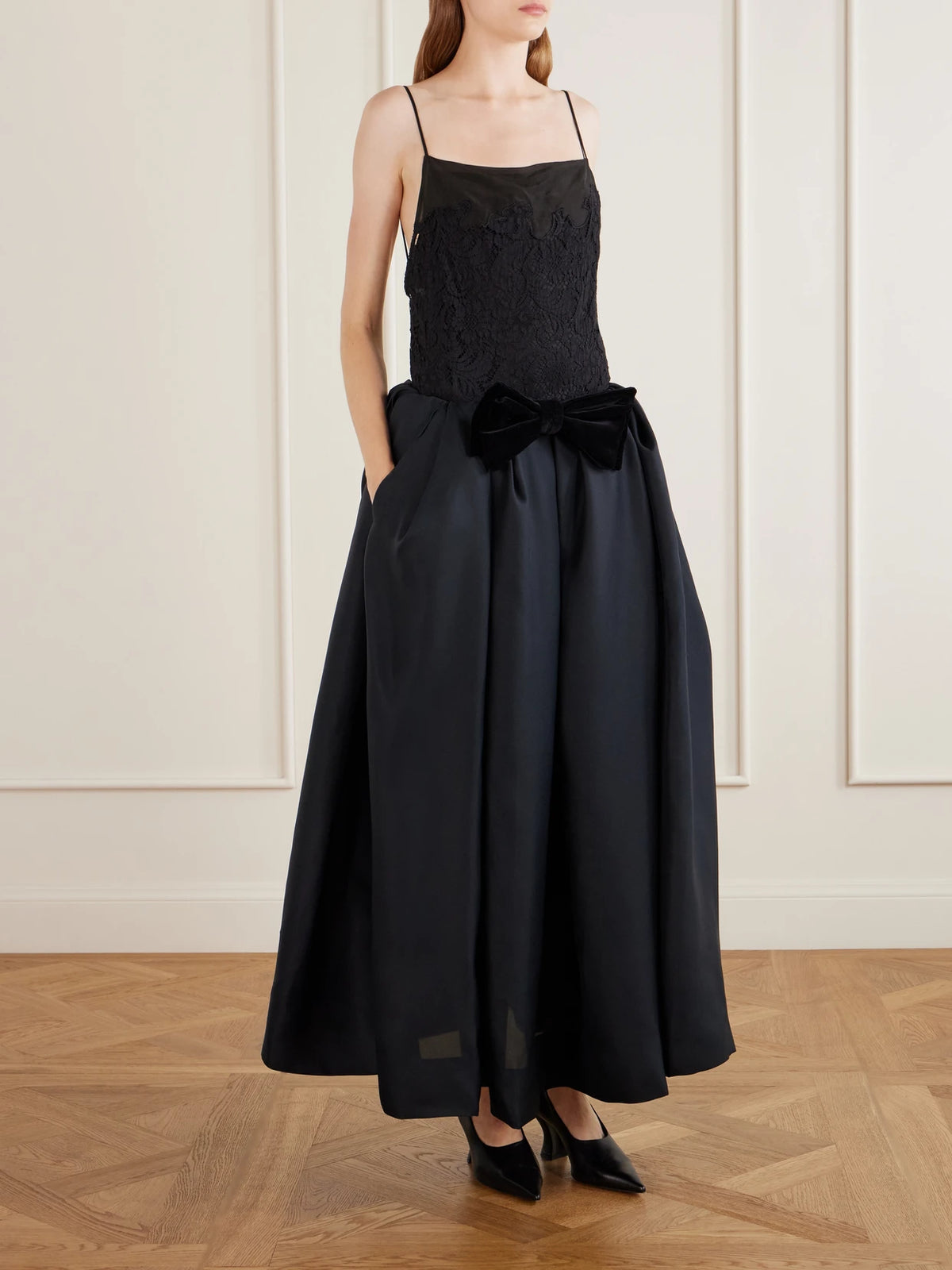 Image of a model wearing Tops. Product name - Neema Lace-trimmed Tencel Lyocell And Silk-blend Voile Tank in Black colour by brand - KHAITE