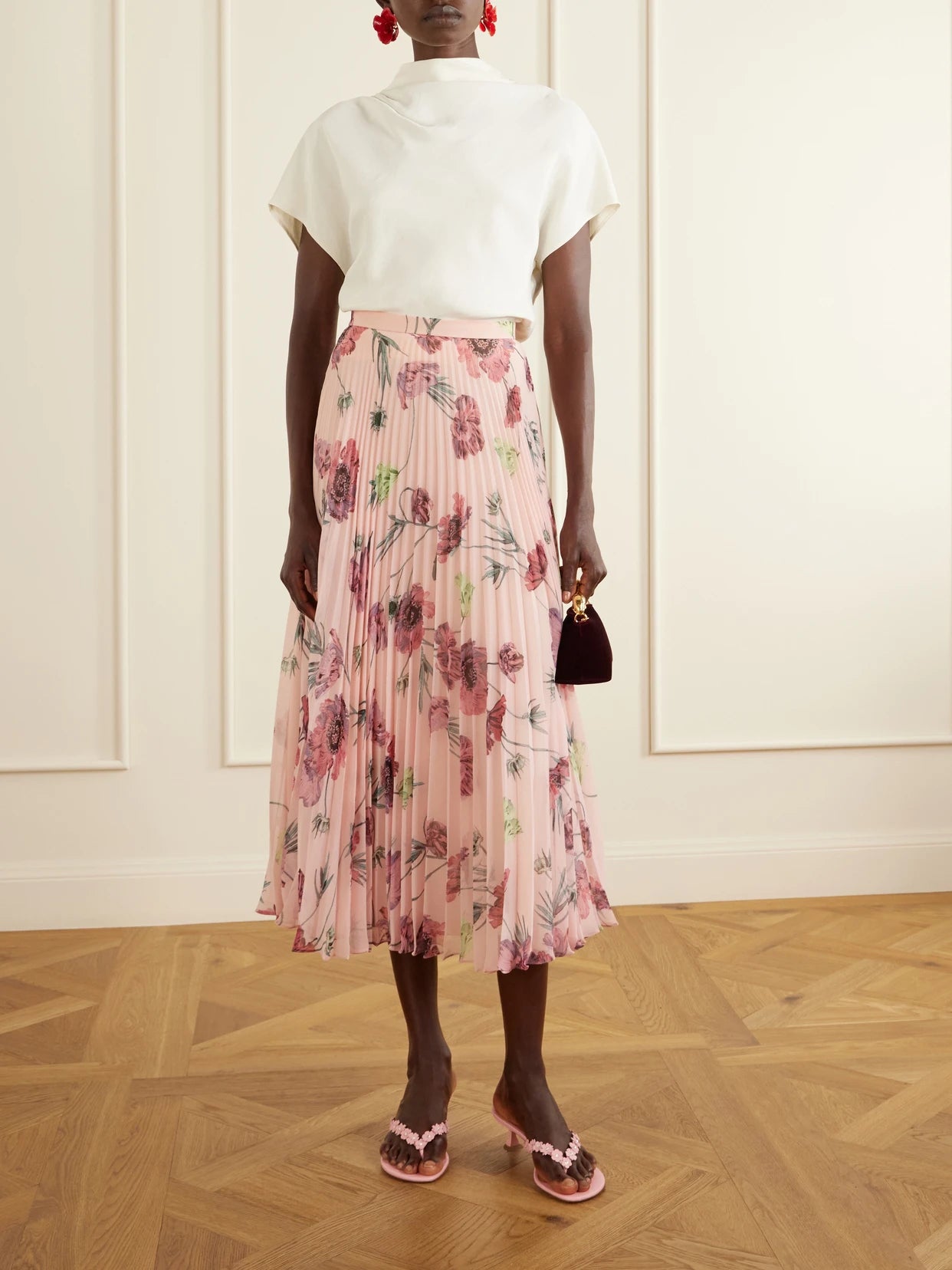 Image of a model wearing Skirts. Product name - Floral-print Plissé-voile Midi Skirt in Pink colour by brand - Erdem