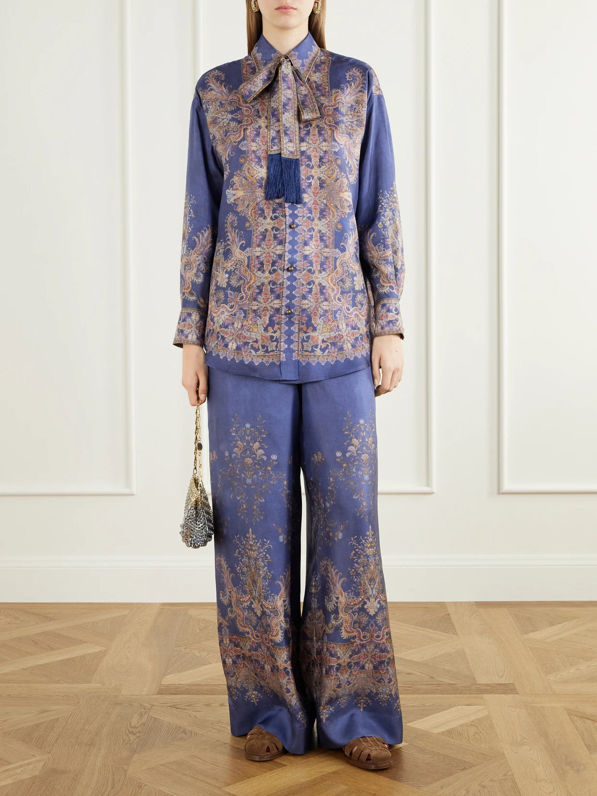 Image of a model wearing Tops. Product name - Valiant Pussy-bow Printed Silk-twill Shirt in Blue colour by brand - Zimmermann
