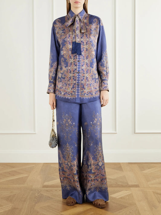 Image of a model wearing Tops. Product name - Valiant Pussy-bow Printed Silk-twill Shirt in Blue colour by brand - Zimmermann