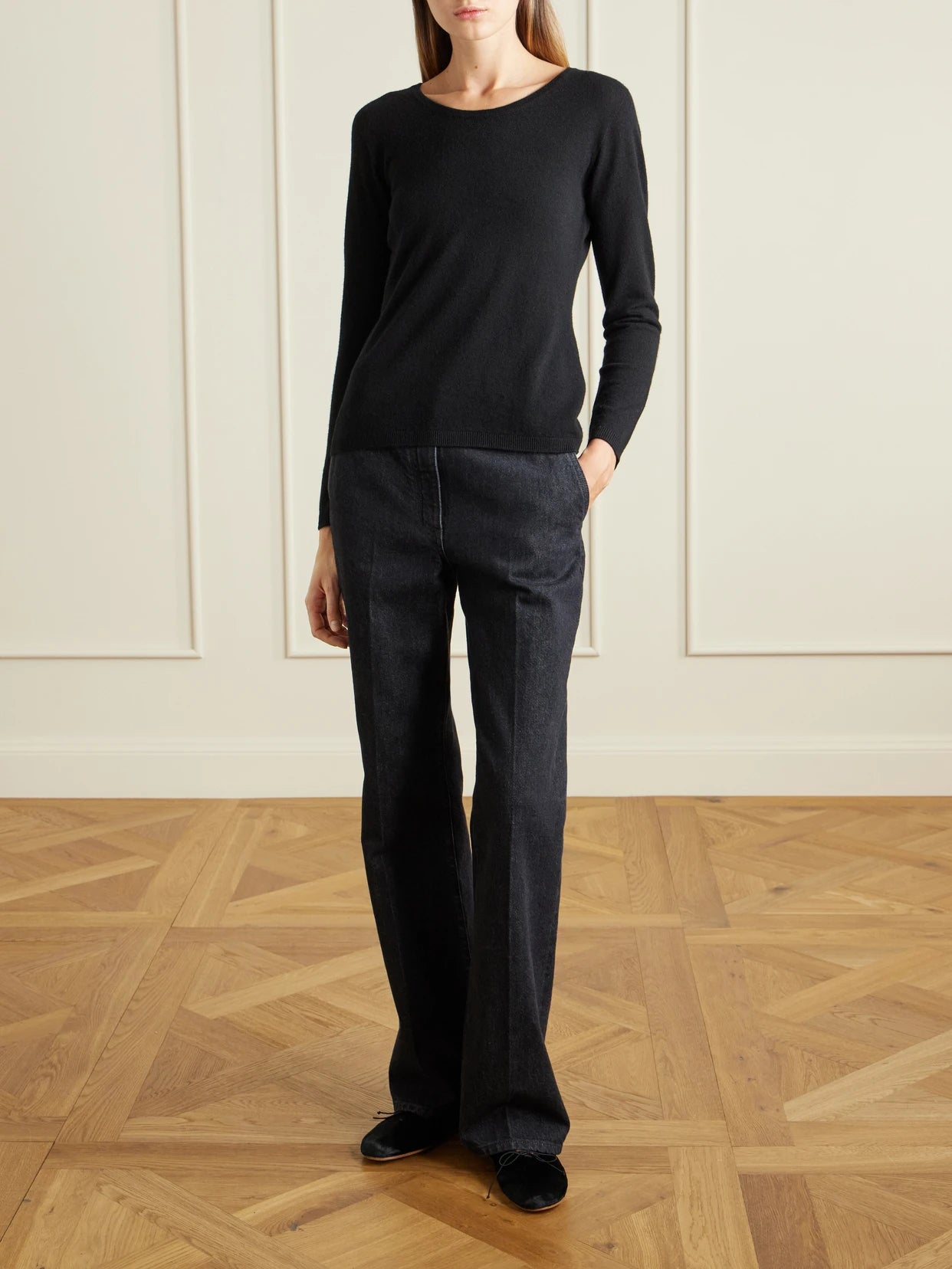 Image of a model wearing Outerwear. Product name - Nezana Cashmere Sweater in Black colour by brand - The Row