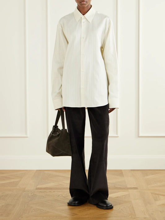 Image of a model wearing Tops. Product name - View Striped Cotton And Silk-blend Shirt in Light blue colour by brand - Studio Nicholson