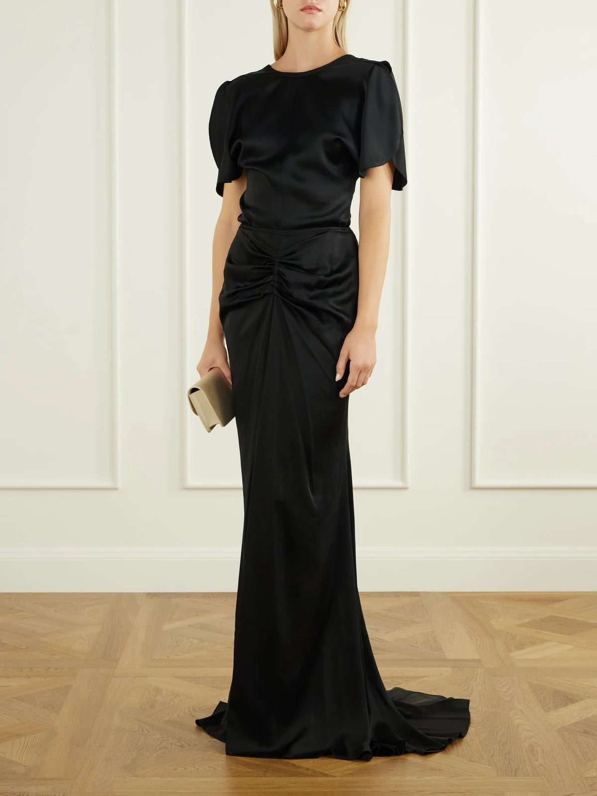 Image of a model wearing Skirts. Product name - Isabella Gathered Satin Maxi Skirt in Black colour by brand - Victoria Beckham