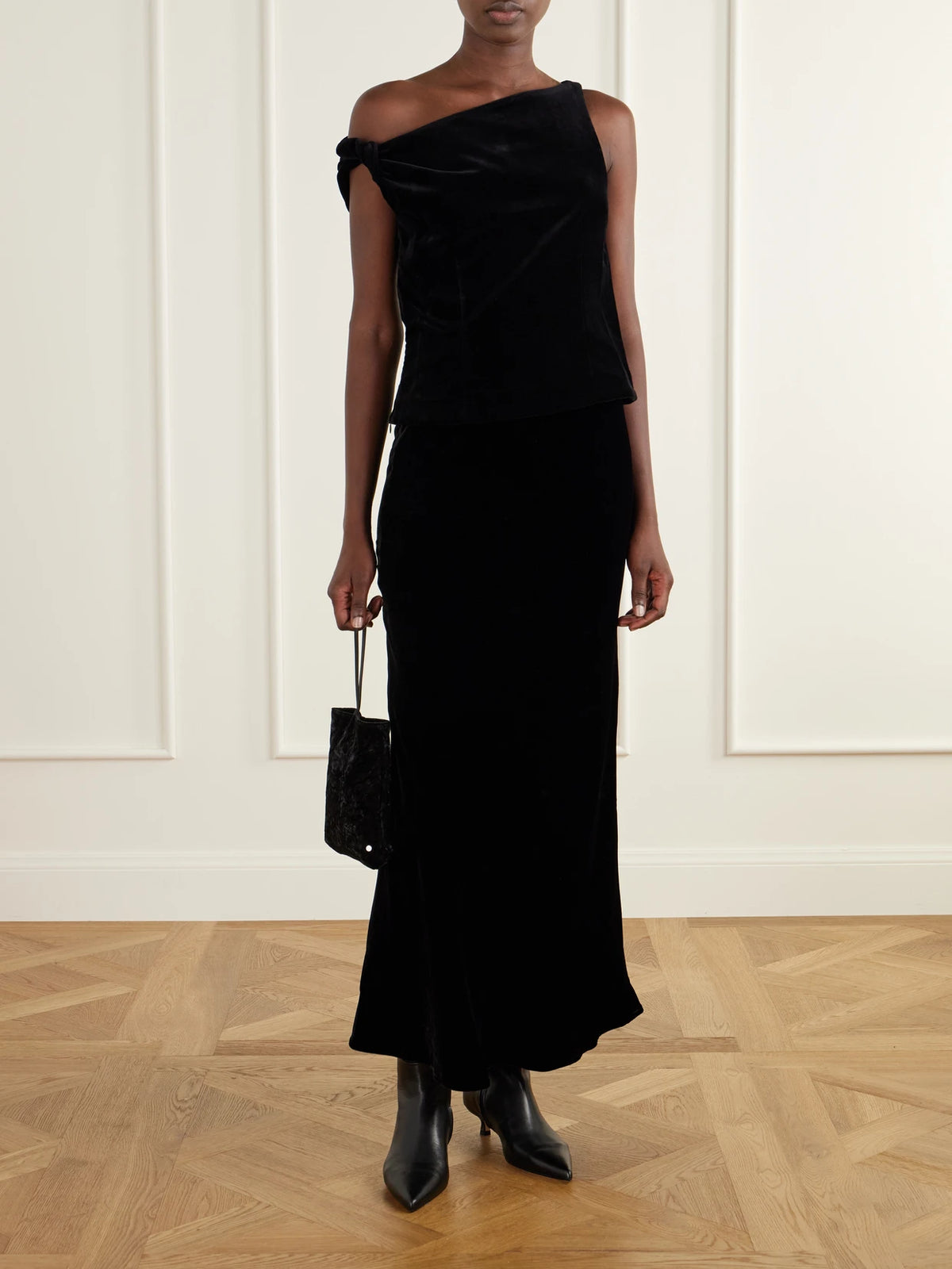 Image of a model wearing Tops. Product name - Draped Cotton-velvet Top in Black colour by brand - RÓHE