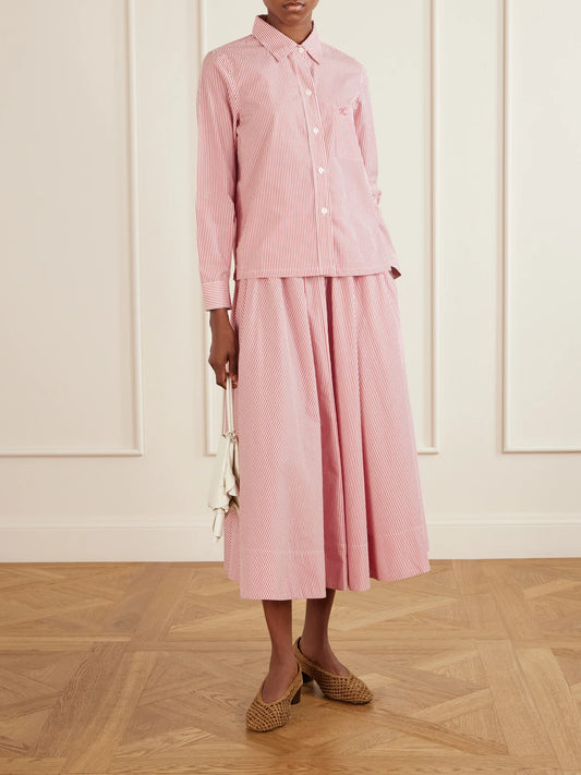 Image of a model wearing Skirts. Product name - Kyria Shirred Striped Cotton-poplin Midi Skirt in Pink colour by brand - Suzie Kondi