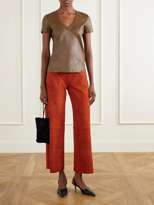 Image of a model wearing Pants. Product name - Lilou Suede Wide-leg Pants in Orange colour by brand - STOULS