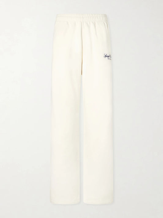 Image of Sleepwear & Loungewear. Product name - Vendome La Embroidered Cotton-fleece Track Pants in Ecru colour by brand - Sporty & Rich