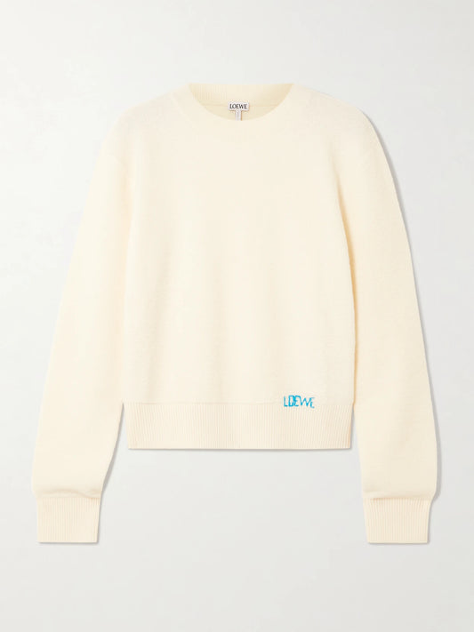 Image of a model wearing Outerwear. Product name - Embroidered Wool Sweater in Ecru colour by brand - LOEWE
