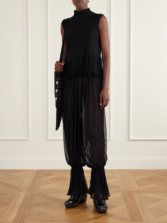 Image of a model wearing Pants. Product name - Keats Onyx Gathered Chiffon Tapered Pants in Black colour by brand - ALIX OF BOHEMIA