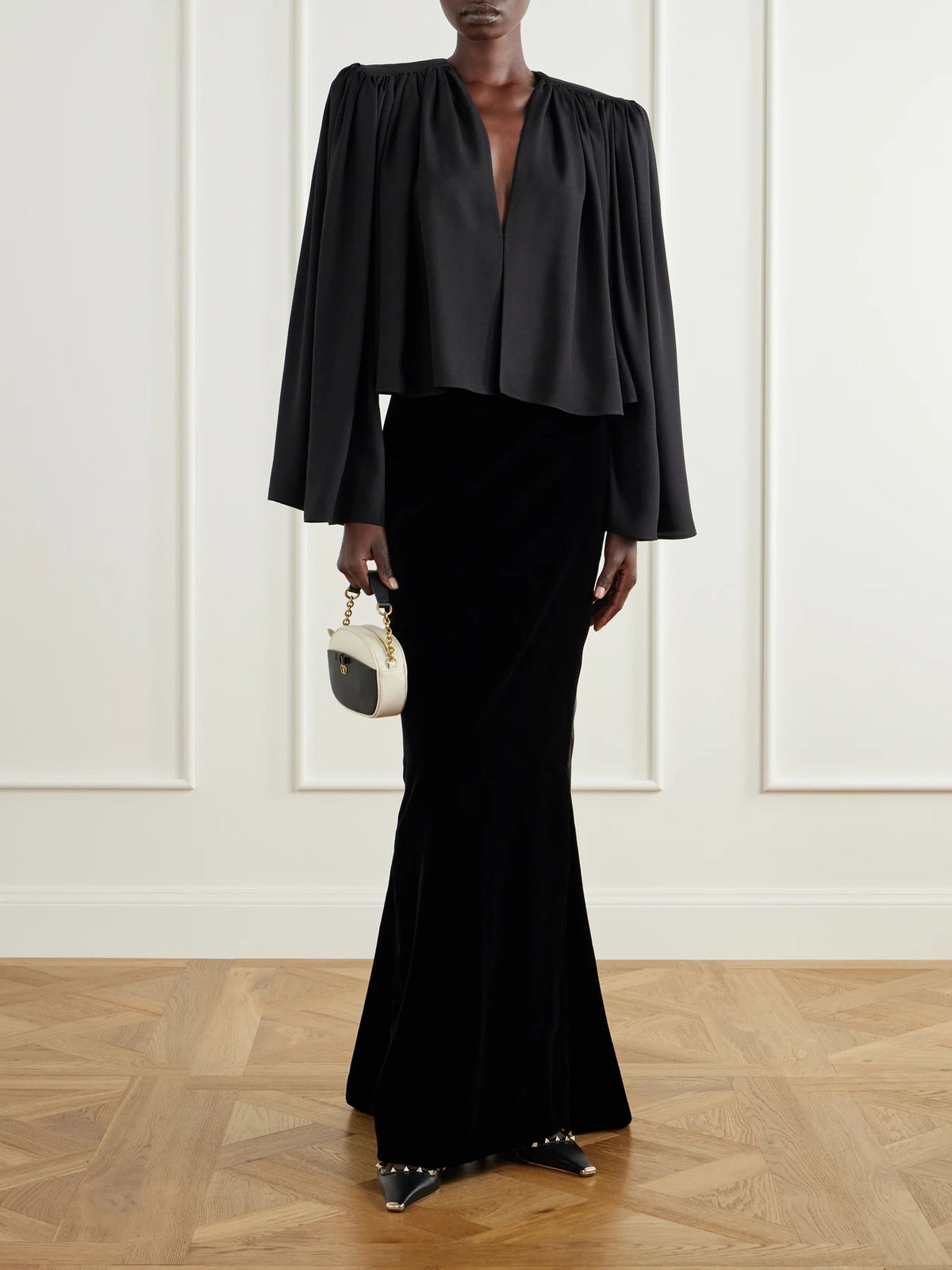 Image of a model wearing Skirts. Product name - Sable Draped Velvet Maxi Skirt in Black colour by brand - Valentino Garavani