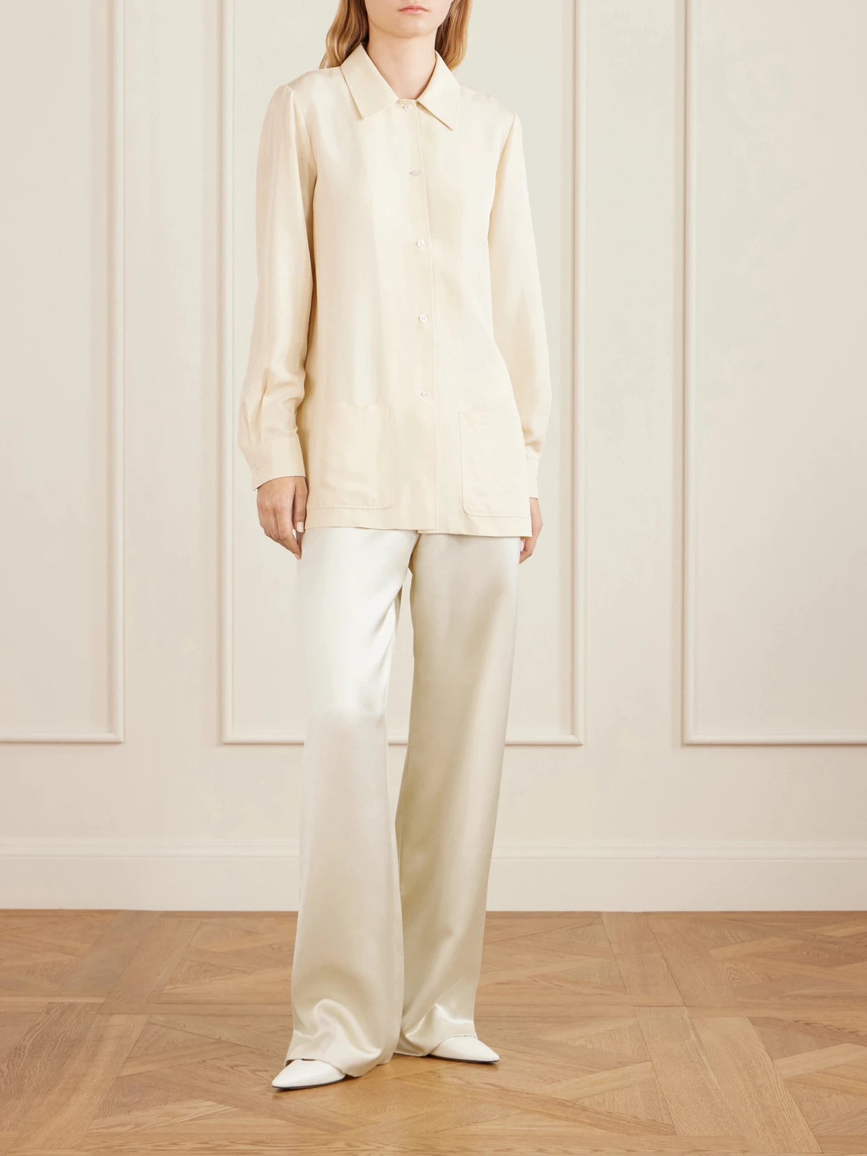 Image of a model wearing Pants. Product name - Ardyn Hammered-silk Wide-leg Pants in Cream colour by brand - The Row