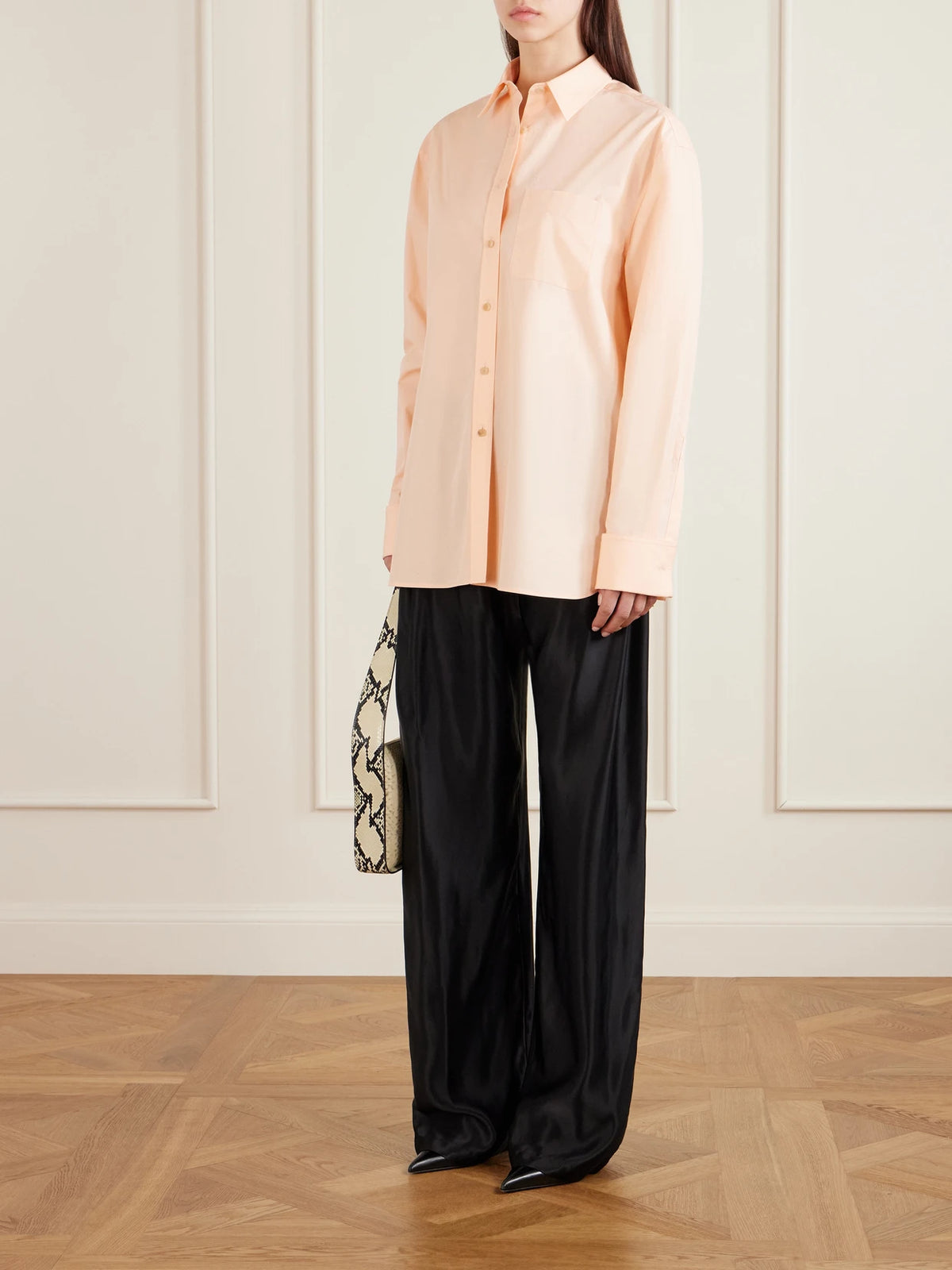 Image of a model wearing Tops. Product name - Newton Cotton-poplin Shirt in Peach colour by brand - KHAITE